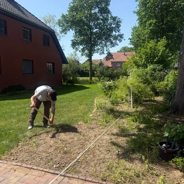 Pflege einer Beetfläche an einem Wohngebäude